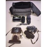 A box containing a Braun Nurnberg Paxina camera, a Fujica 35 auto-m camera and a camera bag with