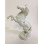 A German white glazed porcelain figure, modelled as a rearing horse designed by Karl Tutter for