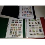 Three albums of GB and world stamps.