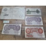 GB bank notes comprising a 1951 white five pound note and four ten shilling notes.