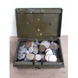 A tin of assorted foreign coins.