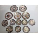 A collection of 13 Royal Crown Derby plates, various sizes