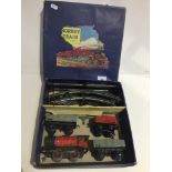 A Hornby 0 gauge clockwork goods train and 2 open waggons set with key