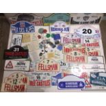 A collection of automotive items to include various plastic rally plates, rally paperwork and badges