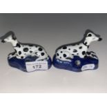 A pair of antique Staffordshire greyhound pen holders with gold anchor backstamp