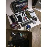 A large box containing scalextric track, accessories, racing trucks and a grand-prix set