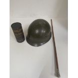 A Royal Marines swagger stick, German para hemet and an explosives container