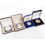 Four silver proof coins.