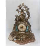 A brass German clock on marble base with key