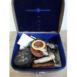 A gent's travel box and contents including a novelty teething ring modelled as a bear, pencil,