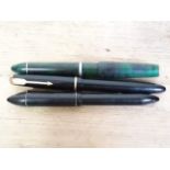 A group of three vintage fountain pens comprising an oversized Harlin, a Parker with nib marked '