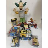 Collection of Simpsons collectables and toys including watches, Krusty the clown figure, soaps and