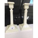 A pair of Sowerby & Company Queen Anne-style machine pressed 'Queensware' fluted column candlesticks