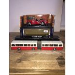 A Kyosho Triumph TR3A (red) 1:18 model in box and a Volvo B 10 M.Ledbuss model in box