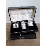 A cased hallmarked silver cruet, a cased set of hallmarked silver handle knives and another set of