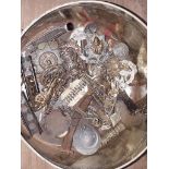 A tin of militaria including cap badges, buttons, dog tags etc.