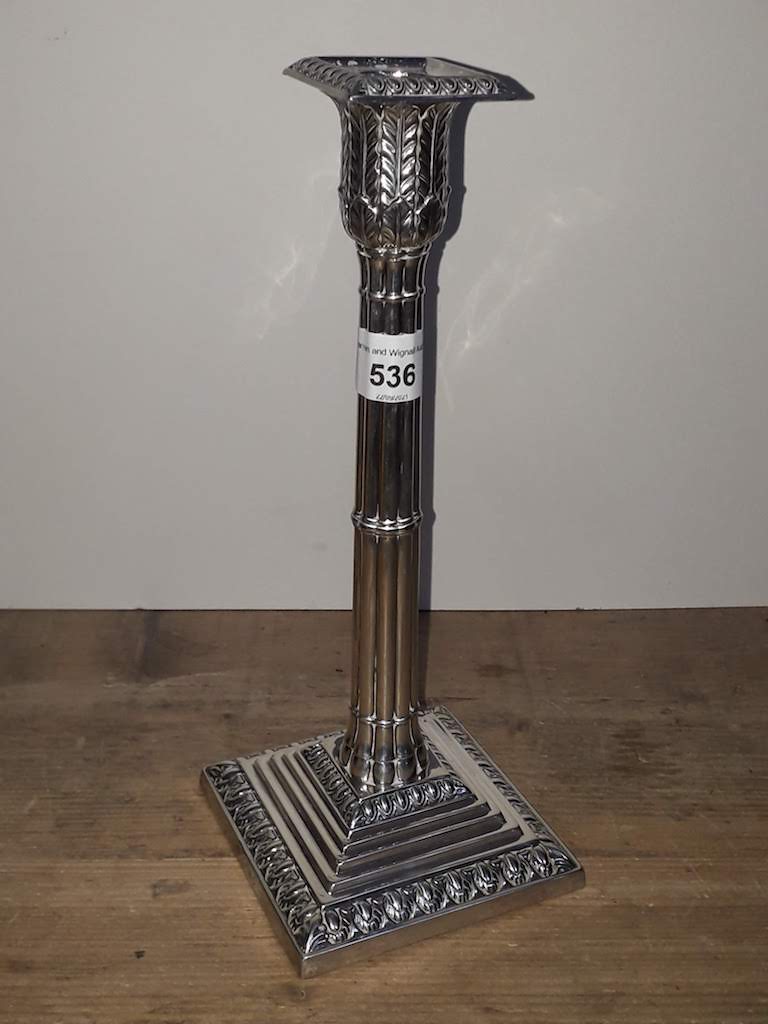 A Victorian silver candlestick of Gothic column form with acanthus capitol and stepped base, William