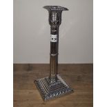 A Victorian silver candlestick of Gothic column form with acanthus capitol and stepped base, William