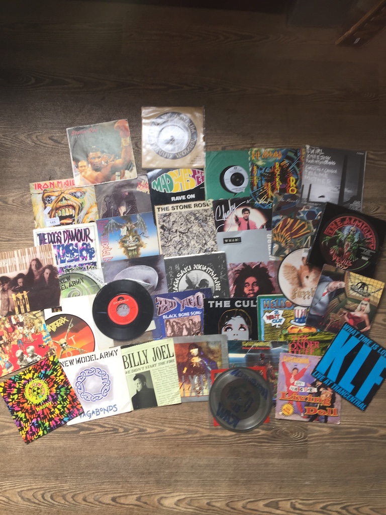 A small collection of 45's to include Pixies, Iron Maiden, Alice Cooper, Happy Mondays, Def