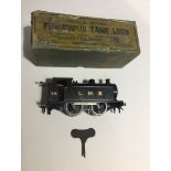 A boxed Bassett-Lowke Ltd Four Coupled Tank Loco clockwork 0 gauge model engine.