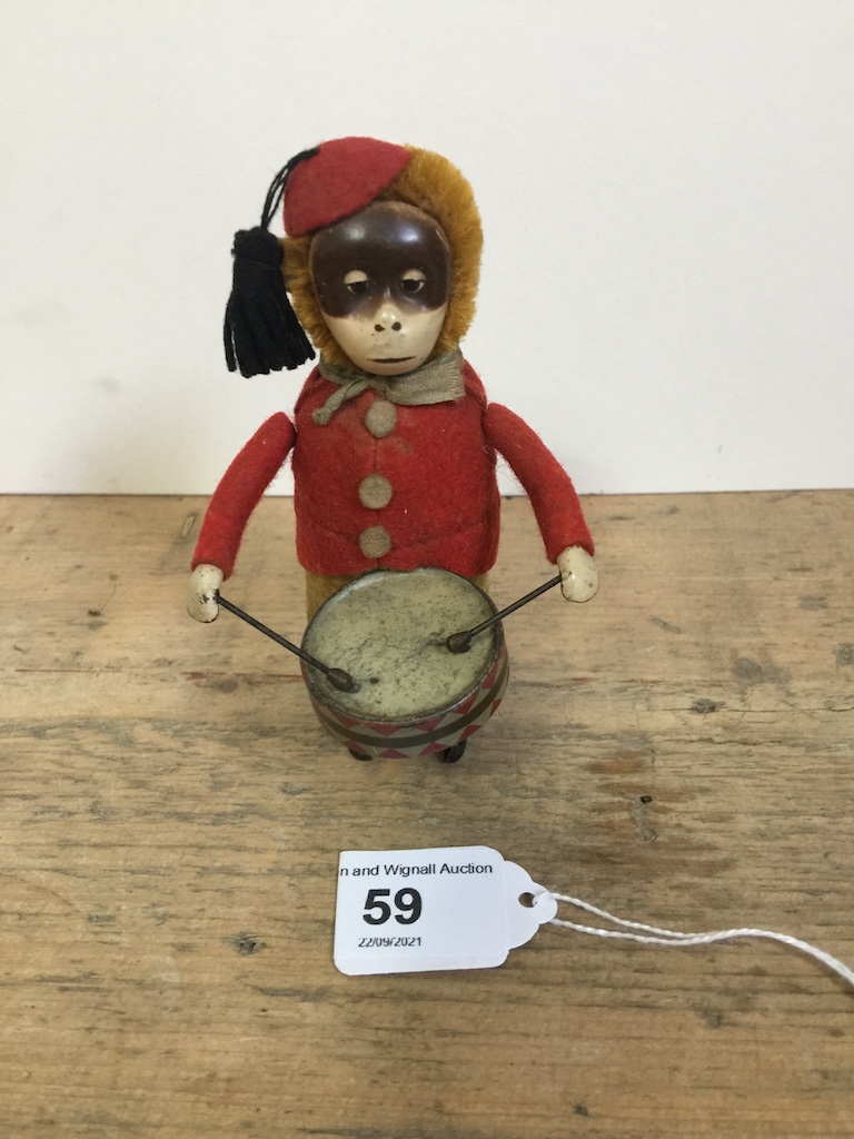 A Schuco patent drumming monkey clockwork toy, with makers mark to foot, no Key, H 11cm