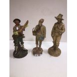 Three terracotta statues, the guitar player, violin player and the fisher vendor.