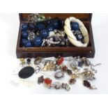 A box of vintage costume jewellery jewellery including an early 20th century yellow metal wire bound