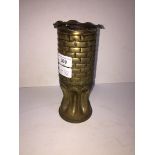 A piece of trench art, a WWI brass artillery shell, dated 1917