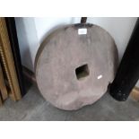 An old millstone, diam. 44cm.