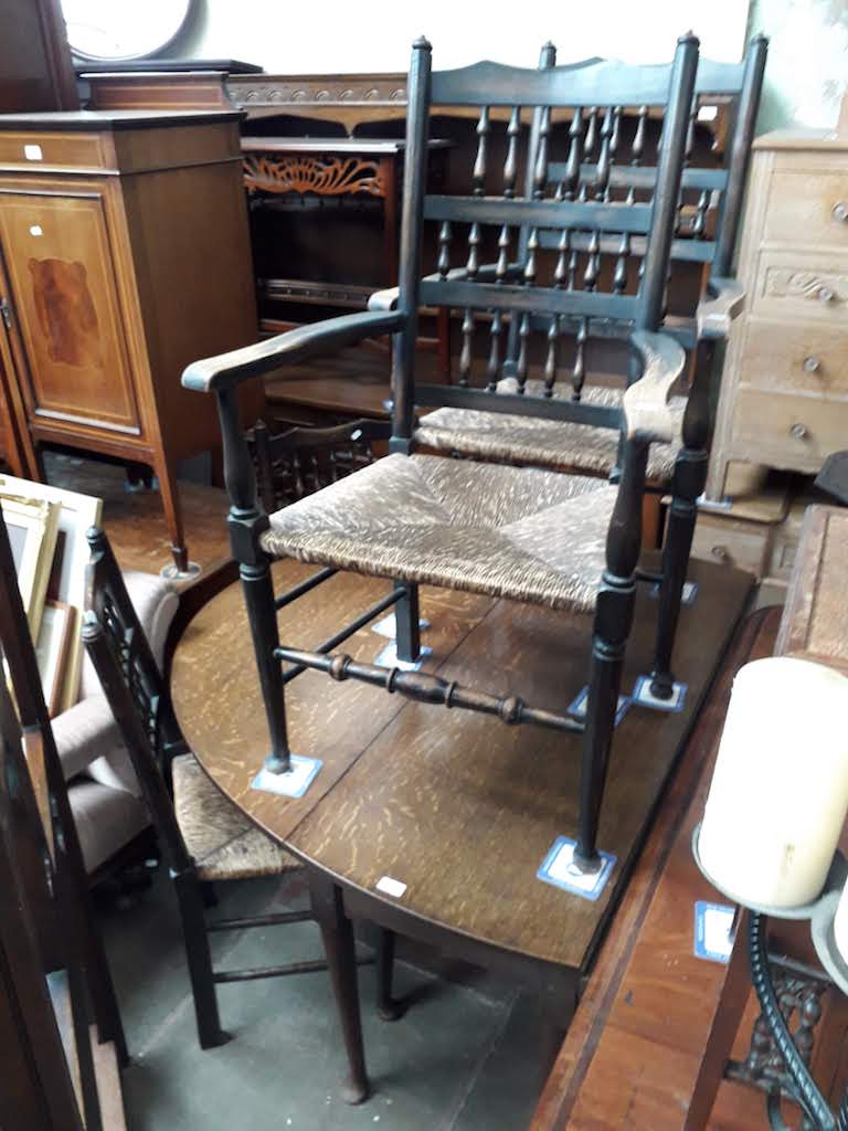 An 18th century oval joined oak gate leg table with pad feet, together with four spindle back and