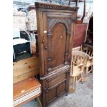 A reproduction oak corner cabinet, probably Titchmarsh and Goodwin or similar.