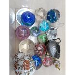 A box of glass paperweights and a pewter dish.