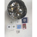 A tin of world coins