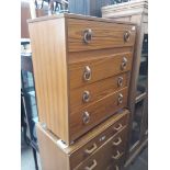 A retro teak effect chest of drawers with ring pull handles.