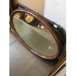 A large oval mirror (length approx 100cm) and a large octagonal bevelled edge mirror (appx 92 x 68