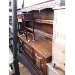 A carved oak dresser, length 168cm, depth 49cm and height 176.5cm