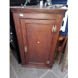 An oak corner cabinet