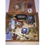A cigar box of curios to include pins, badges, penkives etc.