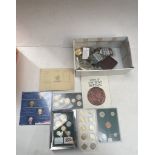 A box of world coin sets and a small box of collectables