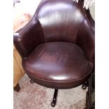 A brown leather office swivel chair.