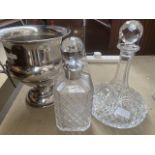 A silver plated ice bucket or campana urn form, together with two decanters.