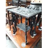 An eastern carved wood and ebonised occasional table, height 64cm, width 53.5cm and depth 37.5cm