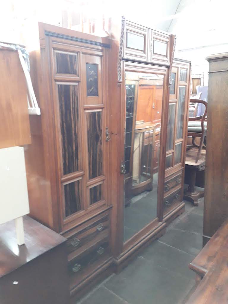 A late Victorian Aesthetic Movement walnut and coromandel wardrobe with Japanned brass panels and