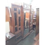A late Victorian Aesthetic Movement walnut and coromandel wardrobe with Japanned brass panels and