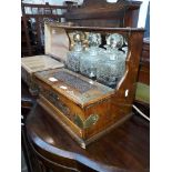 A Victorian oak tantalus with 3 decanters.