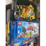 A box of mega blocks and 4 boxed Lego sets.