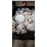 A box of commemorative mugs