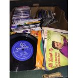 A box of CDs, DVDs and vintage 45s