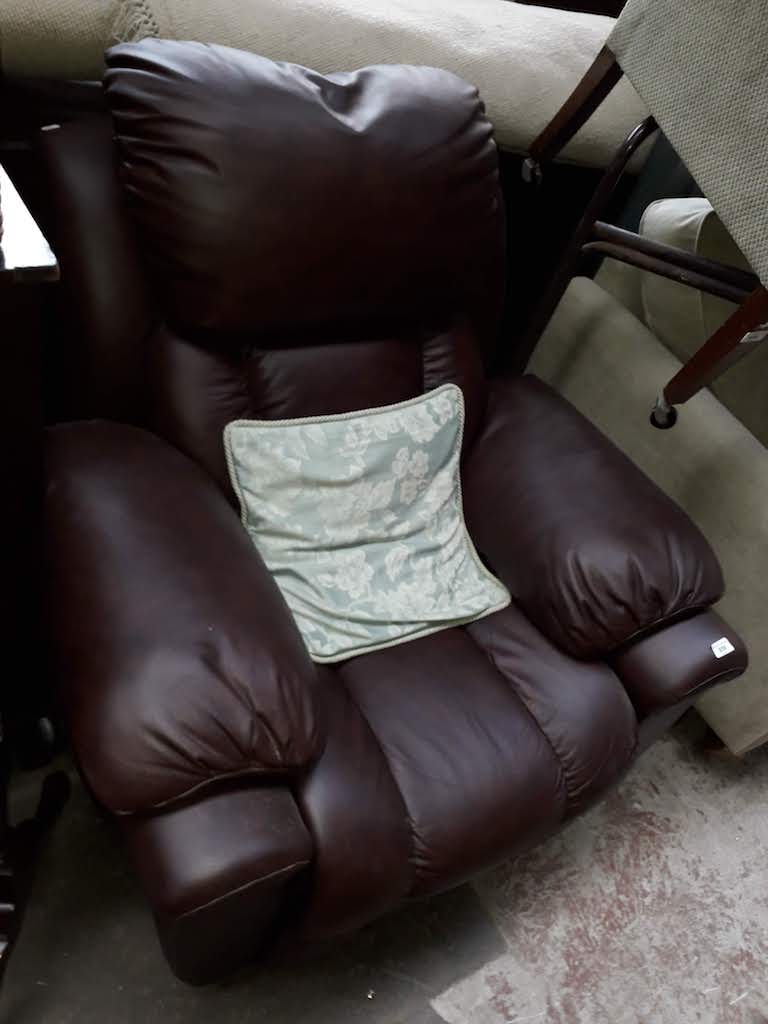 A maroon leather electric recliner armchair