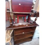 An oak coffee table, an oak bookcase and a drop leaf table.